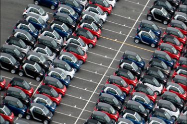 afp : Hundreds of Smart Cars sit in a parking lot after arriving at the auto lots of Port of Baltimore as seen from the air in Baltimore, Maryland, on January 29, 2010.      AFP