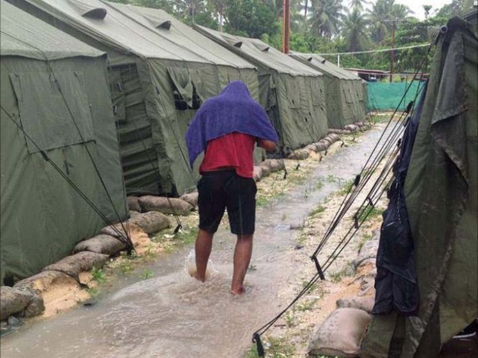 An undated photo obtained from the Refugee Action Coalition on February 18, 2014 shows a man walking between tents at Australia's regional processing centre on Manus Island in Papua New Guinea. One person was killed and 77 injured during a second night of rioting at an Australian immigration detention centre on Papua New Guinea's Manus Island, officials said on February 18.