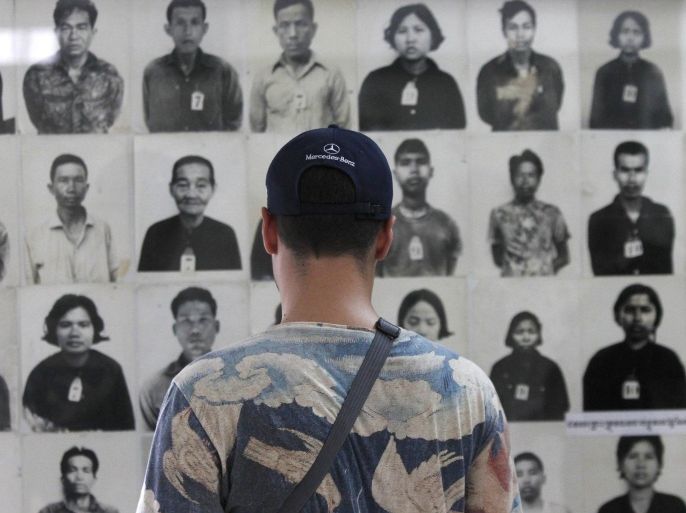 A tourist visits the Tuol Sleng Genocide Museum, also known as the notorious security prison S-21, in Phnom Penh March 3, 2015. A U.N.-backed war crimes tribunal in Cambodia on Tuesday charged two former cadres of the Khmer Rouge regime with crimes against humanity over their alleged roles in the deaths of an estimated 1.8 million people in the 1970s. The tribunal, which has delivered verdicts against only three former Khmer Rouge since it was set up almost a decade ago, announced in a statement that Im Cheam and Meas Muth would be face trial accused of committing murder, slavery and political and ethnic persecution as well as "other inhumane acts." REUTERS/Samrang Pring (CAMBODIA - Tags: CRIME LAW SOCIETY POLITICS)