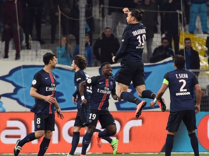 2411 - Marseille, Bouches-du-Rhône, FRANCE : Paris Saint-Germain's Swedish forward Zlatan Ibrahimovic (2nd R) celebrates with teammates after scoring a goal during the French L1 football match between Marseille and Paris-Saint-Germain on February 7, 2015 at the Velodrome stadium in Marseille, southern France. AFP PHOTO / ANNE-CHRISTINE POUJOULAT