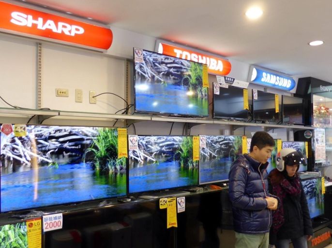 Customers look at SHARP TV screens in an electronics store in New Taipei City, Taiwan, 05 February 2016. According to the Central News Agency, Taiwan Hon Hai Group CEO Terry Gou met with SHARP President Kozo Takahashi at SHARP headquarters in Osaka, Japan, on 05 February 2016. Gou said the two sides have reached 90 per cent consensus on Hon Hai's bailout offer and are expected to sign the deal on 29 February 2016. He said SHARP's losses come from solar power business, not from LCD panel. After takeover, he will let SHARP CORP continue to use the SHARP brand, and help it regain its global leading role as LCD maker. Hon Hai is the world's largest contract electronics manufacturer and assembler of iPhone. It has offered 600 billion yen (Five billion USD) to rescue SHARP, double the amount offered by Japan's state-backed fund.
