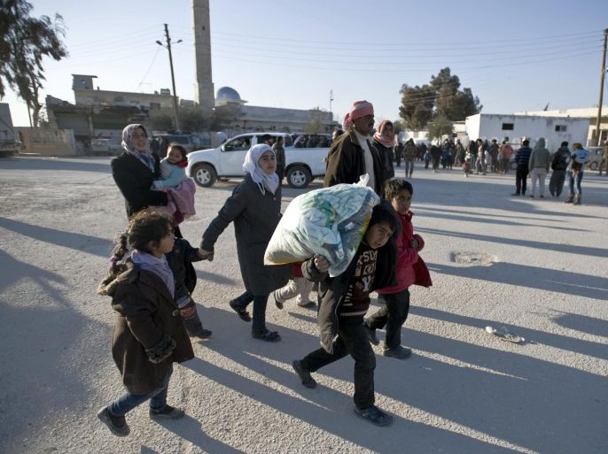 Syrians walk towards the Turkish border at the Bab al-Salam border gate, Syria, Friday, Feb. 5, 2016. Turkish officials say thousands of Syrians have massed on the Syrian side of the border seeking refuge in Turkey. Officials at the government’s crisis management agency said Friday it was not clear when Turkey would open the border to allow the group in and start processing them. The refugees who fled bombing in Aleppo, were waiting at the Bab al-Salam crossing, opposite the Turkish province of Kilis. (Depo Photos via AP) TURKEY OUT
