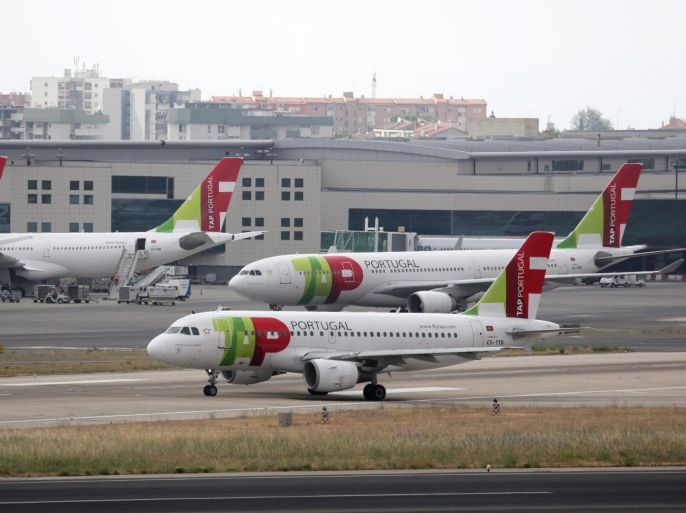 TAP Air Portugal airplanes taxi at Lisbon international airport Thursday, June 11, 2015. The Portuguese government announced it has accepted the bid for 61 percent of the state-owned airline from a consortium led by US businessman David Neeleman, who founded Brazil's third-largest airline Azul. (AP Photo/Armando Franca)