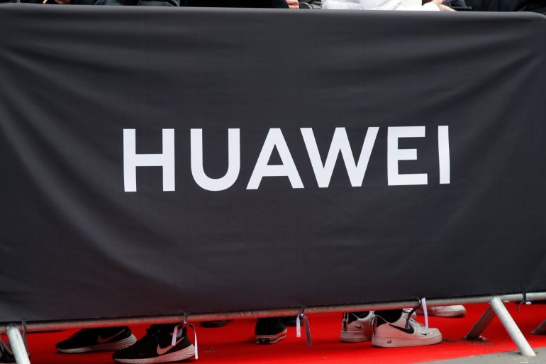 People queue to attend the opening of the new flagship store of Huawei near the Opera in Paris, France March 6, 2020. REUTERS/Charles Platiau
