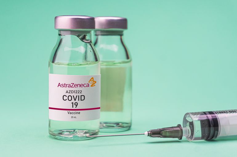Izmir, Turkey - November 18 2020: Coronavirus vaccine concept and background. New vaccine AstraZeneca isolated on green background. Covid-19, 2019-nCov pandemic.